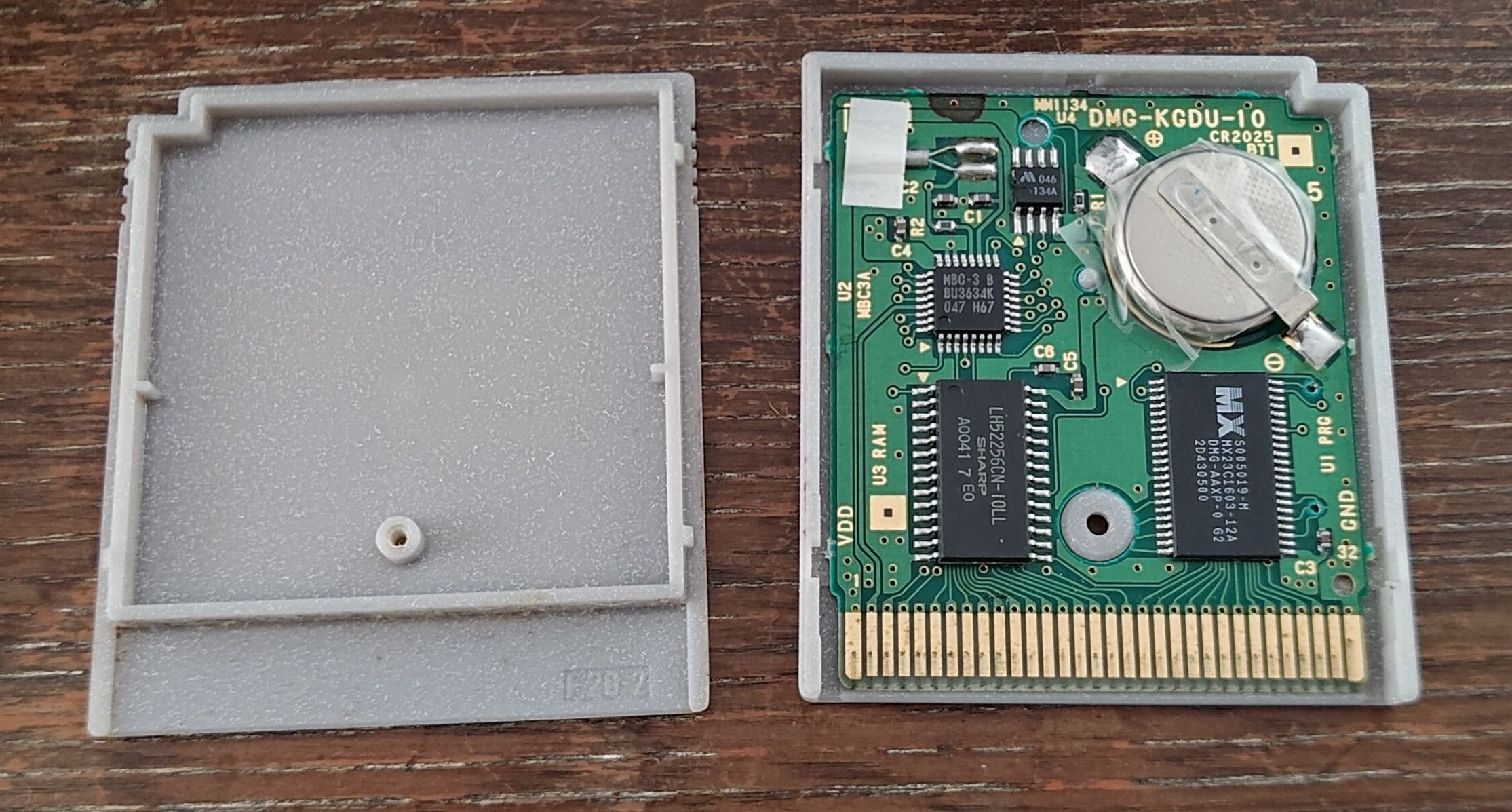 The open Pokémon Silver cartridge - the battery is visibly sellotaped to the PCB